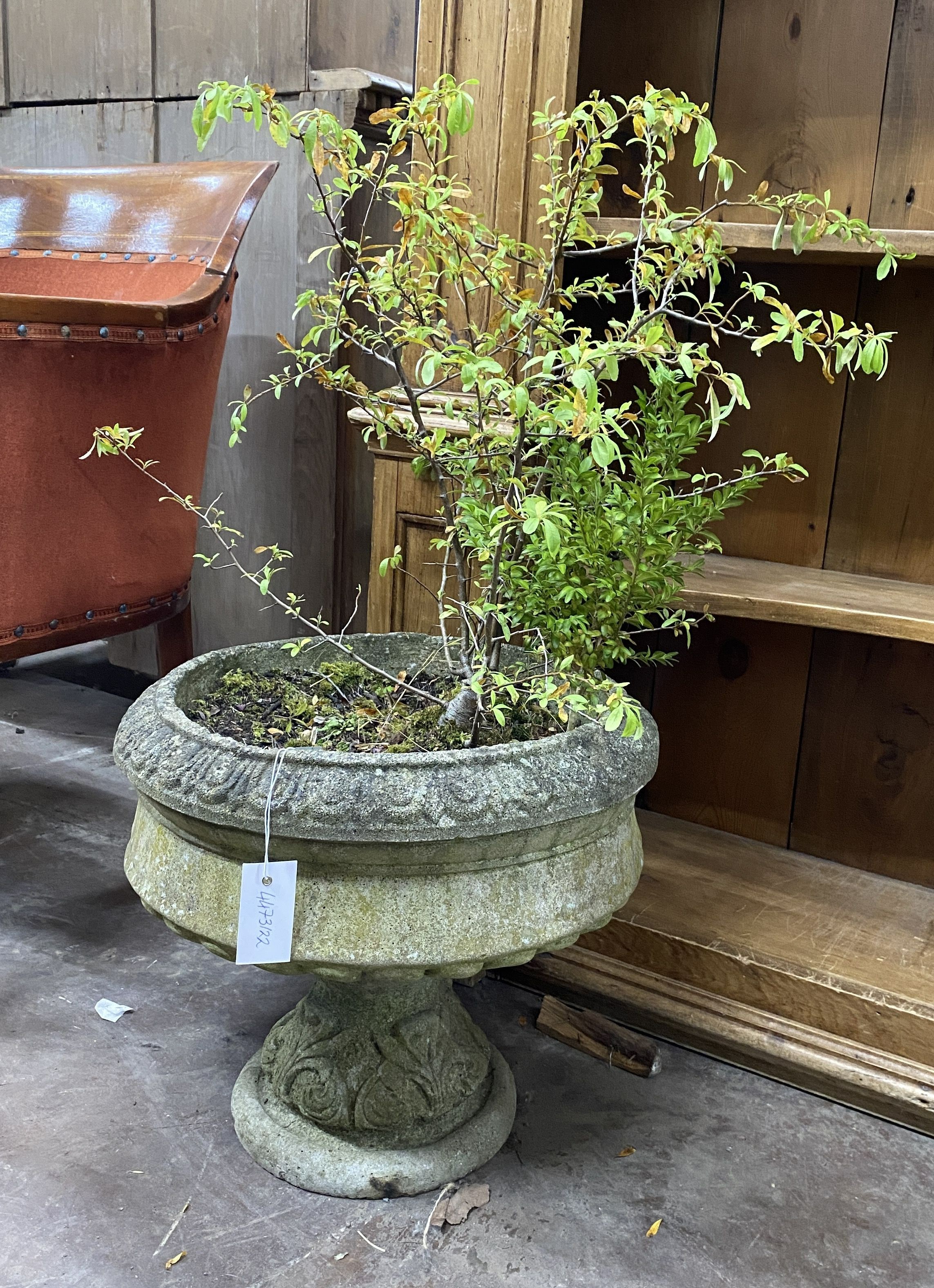 A circular reconstituted stone garden planter, diameter 40cm, height 38cm